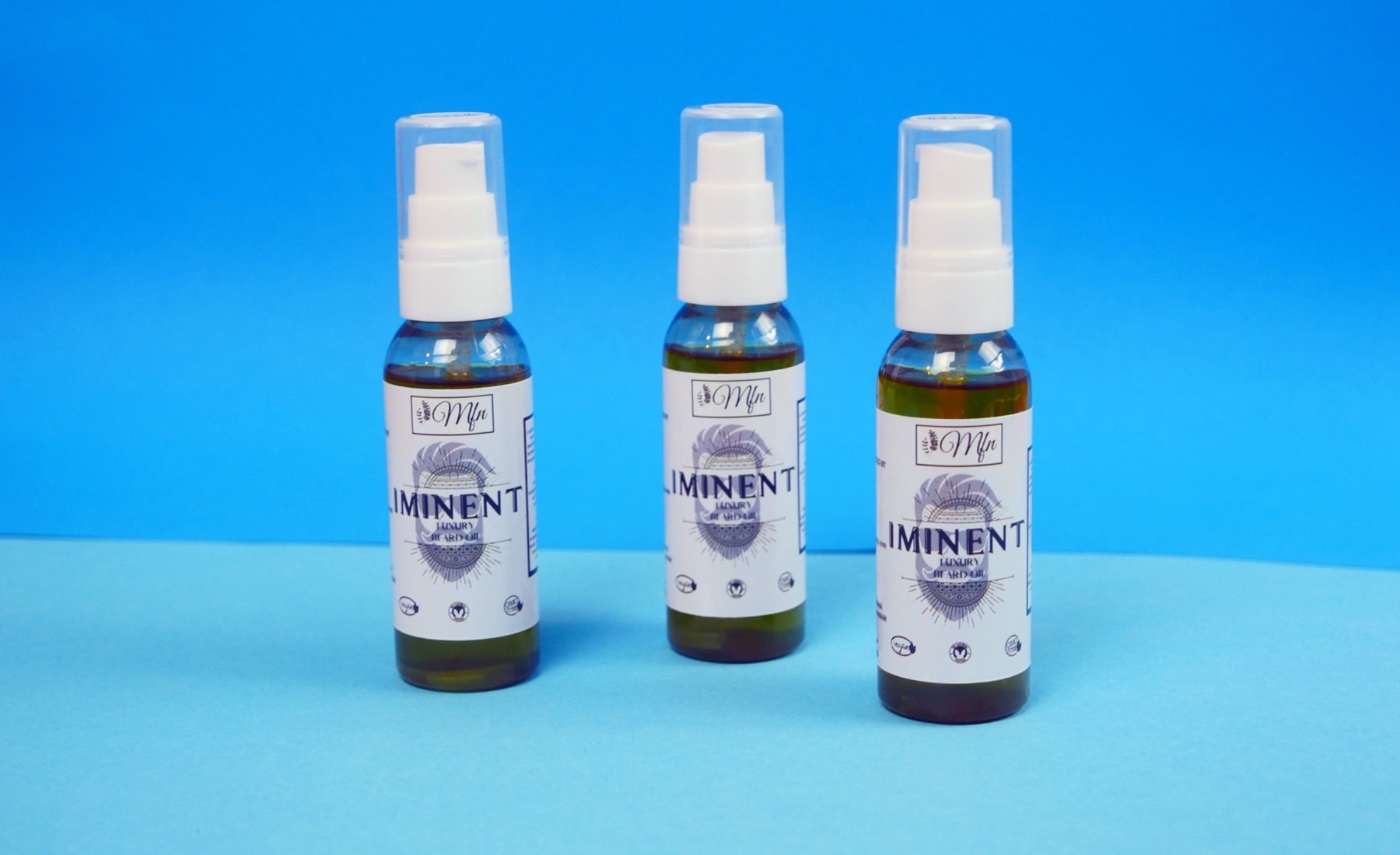 Three bottles of Iminent Luxury Beard Oil